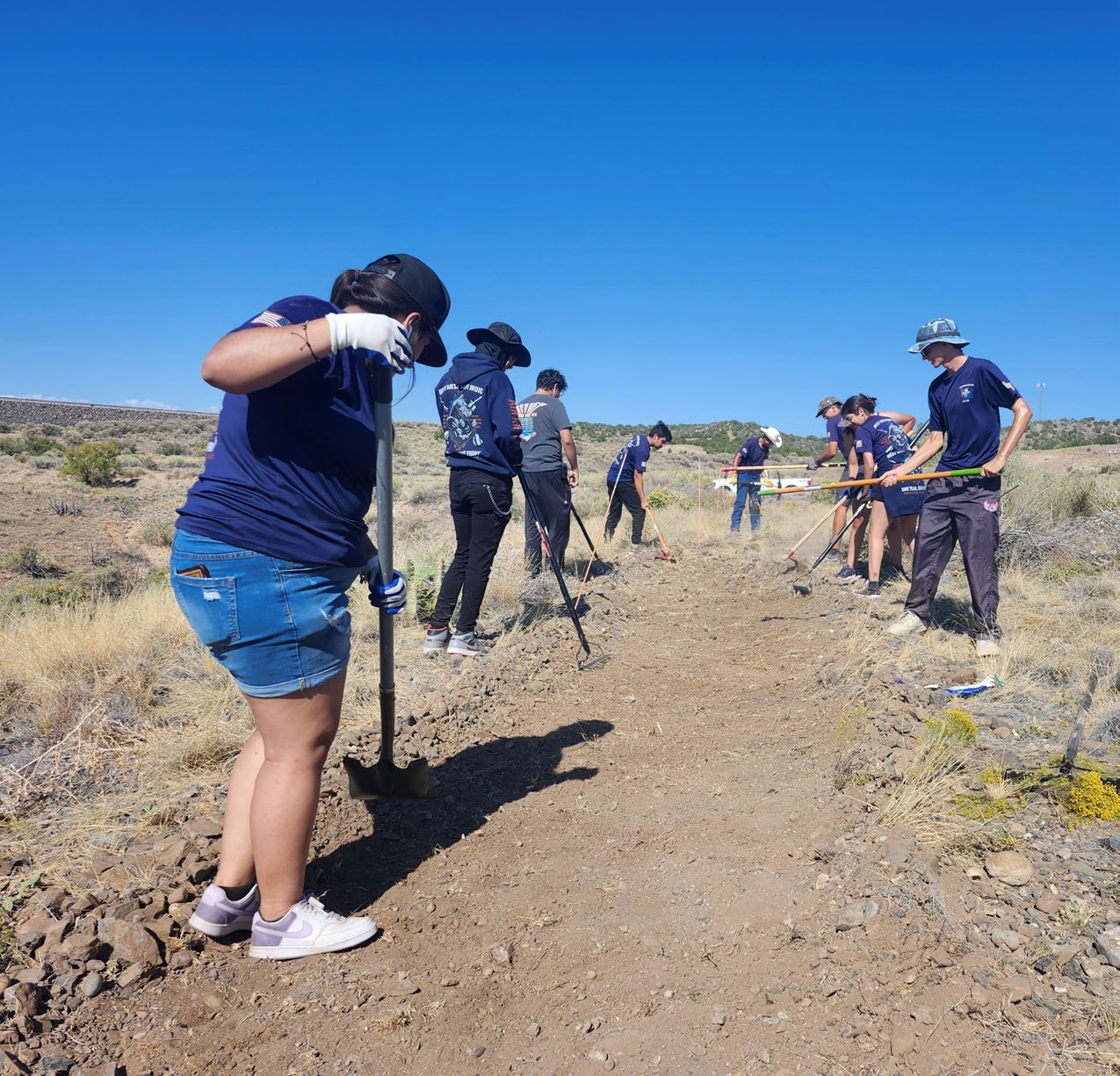 Several West Mesa Junior ROTC students work on an extension of the Nashroo! Trail at the Cochiti Lake Recreation Area, during the National Public Lands Day event, Sept. 28, 2024. Several West Mesa Junior ROTC students work on an extension of the Nashroo! Trail at the Cochiti Lake Recreation Area, during the National Public Lands Day event, Sept. 28, 2024.